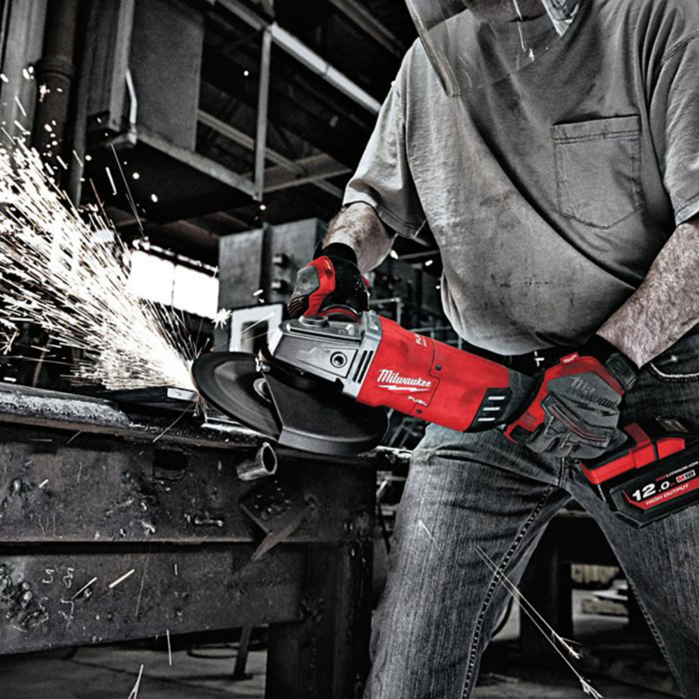 Person with a saw cutting a steel pipe